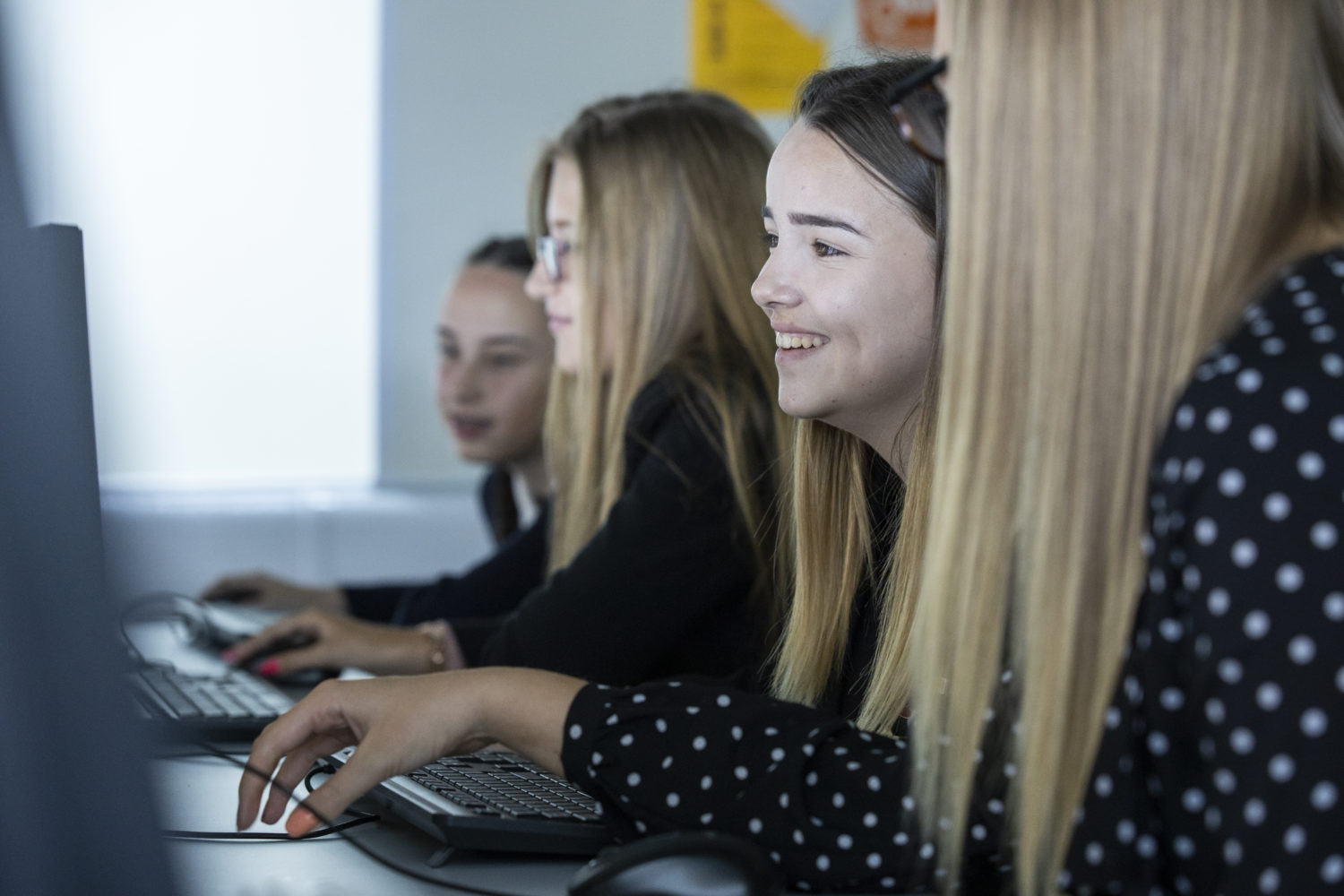 Four female students working on computers