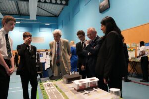 Leigh UTC Year 9 students discussing their community project with Lord Baker and Richard Taylor